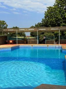 a large swimming pool with blue water at Isamilo Grand Hotel in Mwanza