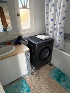 a washing machine in a bathroom with a sink at home zeinbe 2 in Hammamet +26 photos