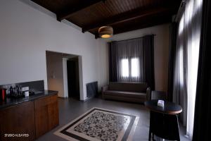 a living room with a couch and a table at Domaine de Chouchene in Şaḩrat al Qashsh