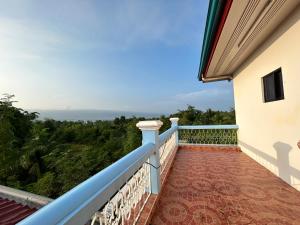 a balcony with a view of the ocean at Pableo's Pension House in Moalboal in Moalboal