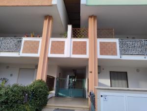 an apartment building with a balcony with a gate at Petit Appartament in Policoro
