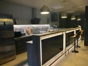 a kitchen with a large counter and a refrigerator at Complex Turistic Emilio in Sviniţa
