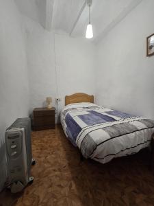 a bedroom with a bed and a suitcase in it at Casa Castillo in Montán
