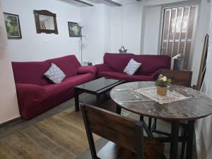 a living room with a red couch and a table at Casa Castillo in Montán +33 photos