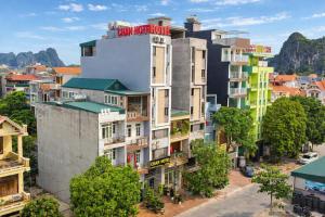 an apartment building with a sign on top of it at Candy Hotel Hạ Long in Ha Long +36 photos