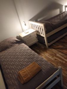 a bedroom with two twin beds and a night stand at ESTEPA CHIMEN in Río Gallegos