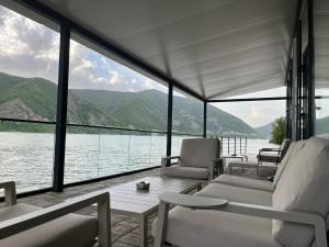 a living room with a view of the water at Complex Turistic Emilio in Sviniţa
