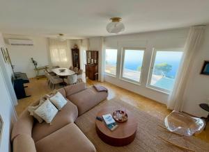 a living room with a couch and a table at Villa Empress in Dramalj
