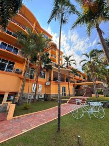 an orange building with two bikes parked in front of it at Isamilo Grand Hotel in Mwanza