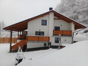 a house in the snow with a snow covered yard at Chata Pod Skarpą in Wieprzec