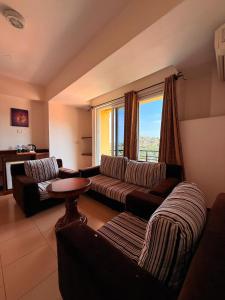a living room with a couch and a table at Isamilo Grand Hotel in Mwanza