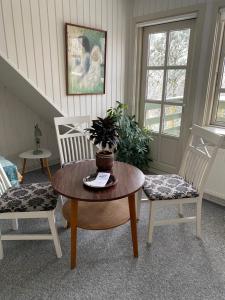 a room with two chairs and a table with a plant on it at Munkebo B&B, Thy in Thisted