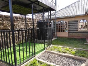 a cage with a trash can inside of a building at Kelhanil Homes in Narok