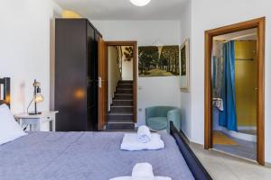 a bedroom with a bed with towels on it at Gallis Villa in Pefkias +42 photos