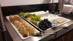 a tray of food on a table with fruit on it at Hotel garni Anger 5 in Bad Frankenhausen