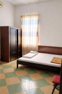 a bedroom with a bed and a window and a chair at Kiến An Hotel Cần Thơ in Can Tho +37 photos