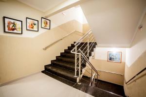 a stairway leading up to a room with two staircases at Apoema Hotel in Cuiabá