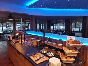 a breakfast buffet on a cruise ship with bread at Haus am See Haselünne in Haselünne