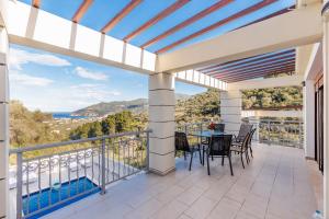 a patio with a table and chairs on a balcony at Gallis Villa in Pefkias