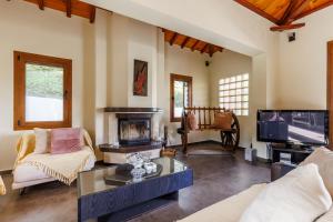 a living room with a fireplace and a tv at Gallis Villa in Pefkias