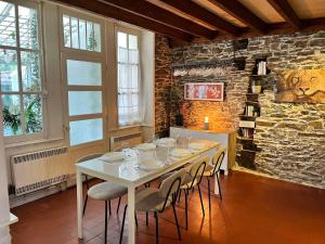 a dining room with a white table and chairs at Guynemer 8pers in Nantes