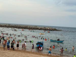 a group of people in the water at a beach at Homestay Xóm Rớ in Ðông Tác (1)