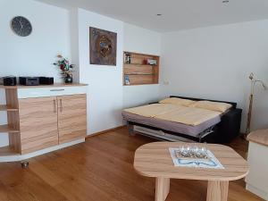 a room with a bed and a table in it at Penthaus Appartement in Sankt Michael im Lungau