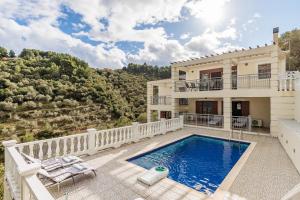 a villa with a swimming pool and a balcony at Gallis Villa in Pefkias