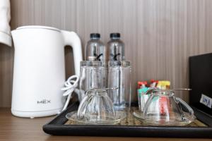 a tray with four glass containers on a table at Tongtong Garden Holiday Hotel普吉岛通通花园酒店 in Rawai Beach