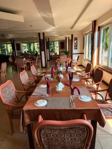 a dining room with tables and chairs in a restaurant at Isamilo Grand Hotel in Mwanza