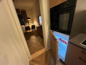 a hallway leading to a kitchen with a living room at Triberg City Apartment 1 in Triberg