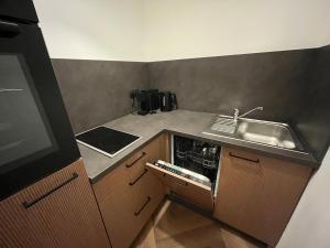 a small kitchen with a sink and a counter at Triberg City Apartment 1 in Triberg