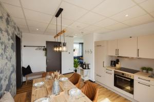 a kitchen and dining room with a table and chairs at HYGGE HOMES Apartment 'Scandi Sunset' in Winsen