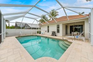 a swimming pool in the backyard of a house at Neapolitan Vacation Rentals - Pet Friendly, Newly Updated Luxury Home with Private Pool! Complete Privacy and Only a 10 Minute Walk to Vanderbilt Beach Close to Mercato and the Best of Naples in Naples
