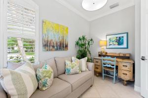 a living room with a couch and a desk at Neapolitan Vacation Rentals - Pet Friendly, Newly Updated Luxury Home with Private Pool! Complete Privacy and Only a 10 Minute Walk to Vanderbilt Beach Close to Mercato and the Best of Naples in Naples