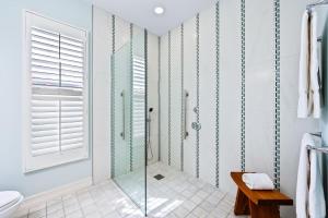 a bathroom with a glass shower and a toilet at Neapolitan Vacation Rentals - Pet Friendly, Newly Updated Luxury Home with Private Pool! Complete Privacy and Only a 10 Minute Walk to Vanderbilt Beach Close to Mercato and the Best of Naples in Naples