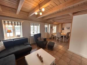a living room with a couch and a table at Hygge in Wrixum