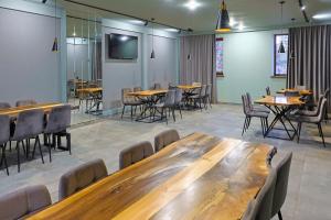 a conference room with wooden tables and chairs at Ani Hotel in Maralik