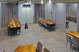 a conference room with wooden tables and chairs at Ani Hotel in Maralik