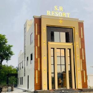 a building with a sign on top of it at SR Resort in Milkīpur