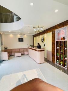 a man sitting at a bar in a restaurant at SR Resort in Milkīpur
