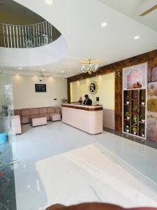 a lobby of a restaurant with a man standing at a counter at SR Resort in Milkīpur