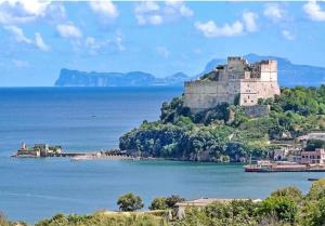 a castle on an island in the water at Domus Anna in Bacoli