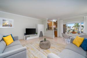 a living room with two couches and a television at Vila da Praia by ALgest in Alvor