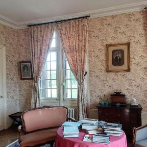 a room with a table and a chair and a window at Manoir de Villers in Saint-Pierre-de-Manneville +10 photos