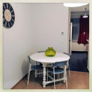 a table with chairs and a vase on top of it at Second floor at home in Brussels