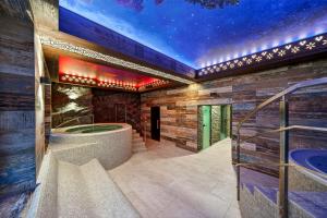 a wellness room with a jacuzzi in a building at Grand Regle Resort & SPA in Poronin