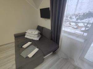 a living room with a couch and a window at Hotel Osher in Bukovel +162 photos