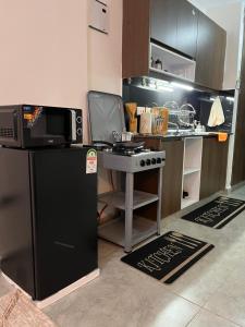 a small kitchen with a microwave and a stove at Ems Haven Apartment in Ongata Rongai  +10 photos