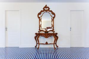 a dressing table with a mirror on it in a room at Villa Bellarosa in Sorrento